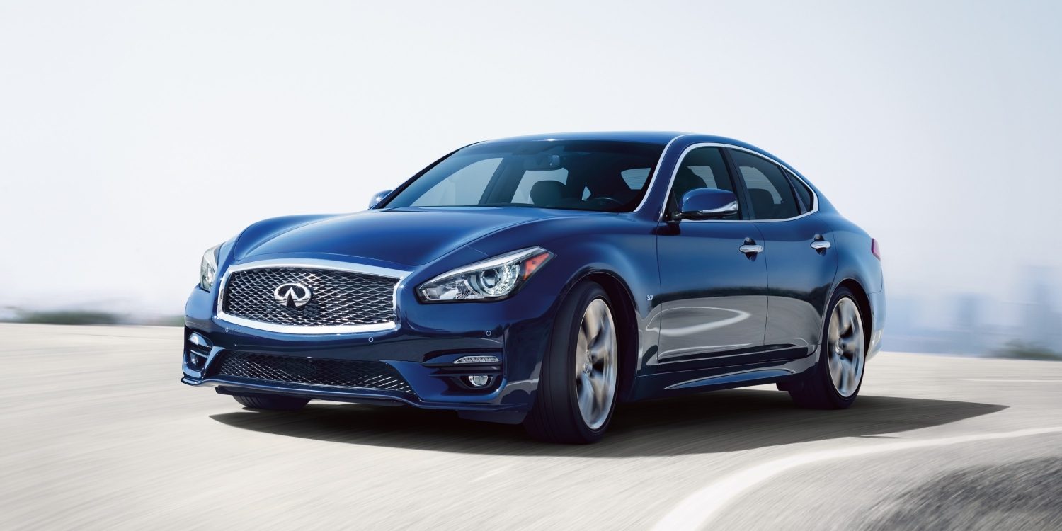 A luxurious blue 2019 q70 sedan driving fast on the road