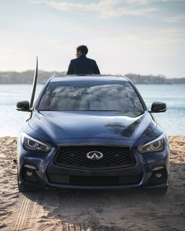 Front view of 2024 INFINITI Q50 parked near a lake